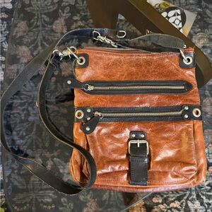 TANO Black and Brown Crossbody Buckle Bag. Adjustable strap.